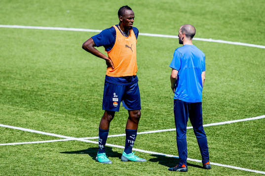 Usain Bolt and Martin Foyston, assistant coach of