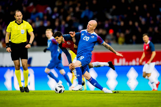 Tarik Elyounoussi of Norway and Emil Hallfreðsson of
