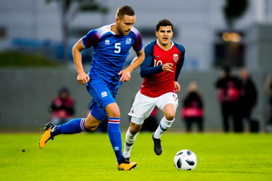Sverrir Ingason of Iceland and Tarik Elyounoussi of Norway