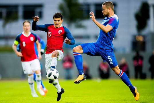 Tarik Elyounoussi of Norway and Sverrir Ingason of Iceland