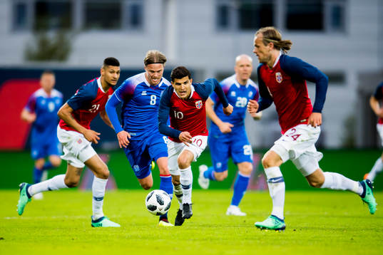 Birkir Bjarnason of Iceland and Tarik Elyounoussi of Norway