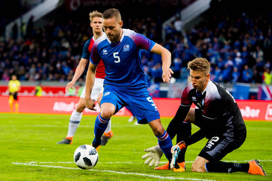 Sverrir Ingason and goalkeeper Frederik Schram of Iceland