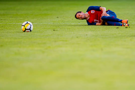 Martin Linnes of Norway lies down with an injury