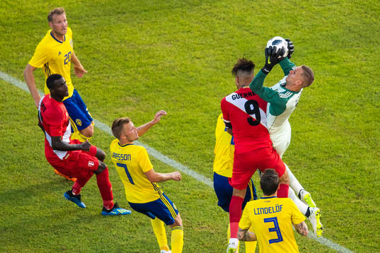 Paolo Guerrero of Peru competes for the ball with
