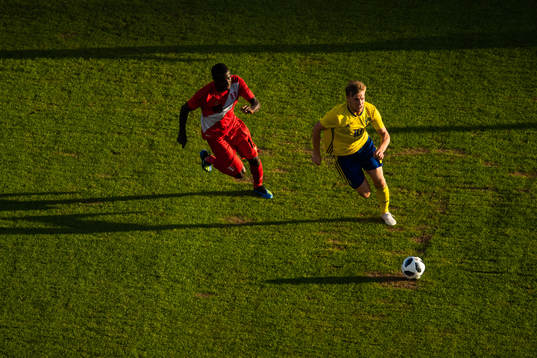 Christian Ramos of Peru chases Marcus Berg of Sweden