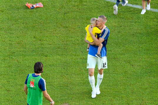 Goalkeeper Karl-Johan Johnsson of Sweden with his child