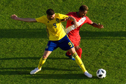 Marcus Berg of Sweden and Pedro Aquino of Peru