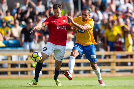 Giovanni of Brazil competes for the ball with Ronny Johnsen