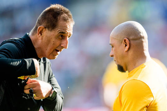 Esse Baharmast, referee, and Roberto Carlos of Brazil
