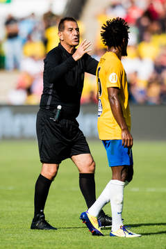 Esse Baharmast, referee, and Zé Roberto of Brazil