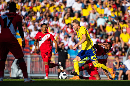 Ola Toivonen of Sweden challenges Renato Tapia of Peru