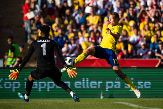 Viktor Claesson of Sweden challenges goalkeeper Pedro