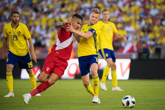 Paolo Guerrero of Peru is being stopped by Sebastian