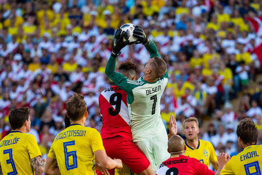 Paolo Guerrero of Peru collides with goalkeeper Robin Olsen
