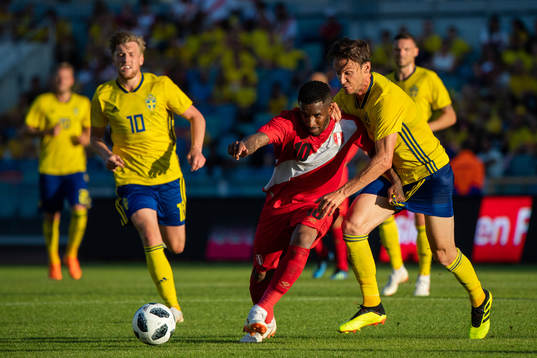Jefferson Farfan of Peru competes for the ball with Albin