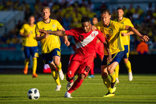 Jefferson Farfan of Peru competes for the ball with Albin