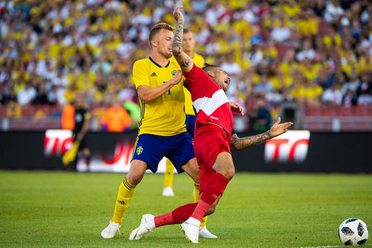 Paolo Guerrero of Peru falls when competing for the ball