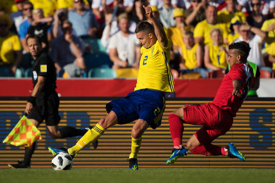 Mikael Lustig of Sweden and Miguel Trauco of Peru