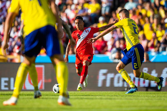 of PeruChristian Cueva of Peru competes for the ball with