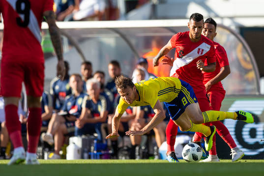Albin Ekdal of Sweden competes for the ball with Miguel