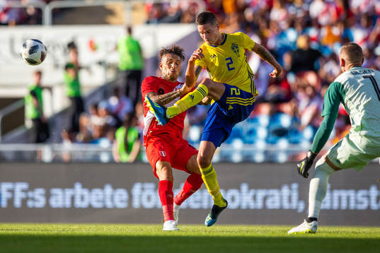 Mikael Lustig of Sweden clears the ball in front of Paolo