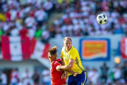 Paolo Guerrero of Peru competes for the ball with Andreas