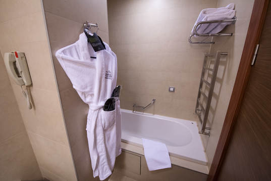 A bathrobe hanging inside a bathroom