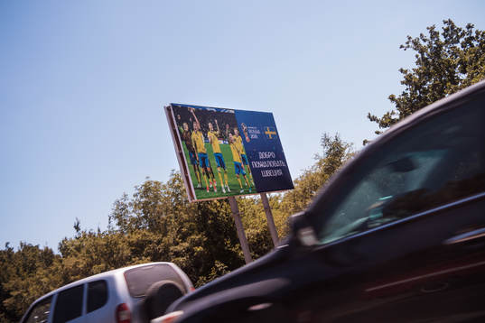 A sign showing the Swedish football team cheering is seen