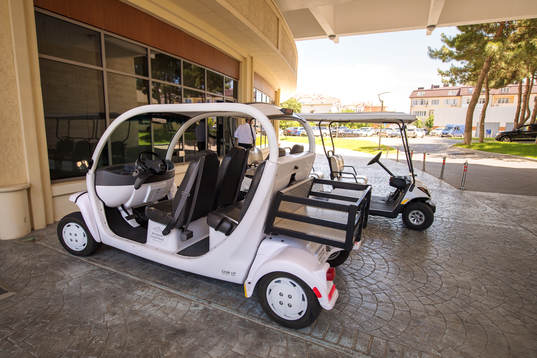 Golf cars outside the Kempinski Hotel