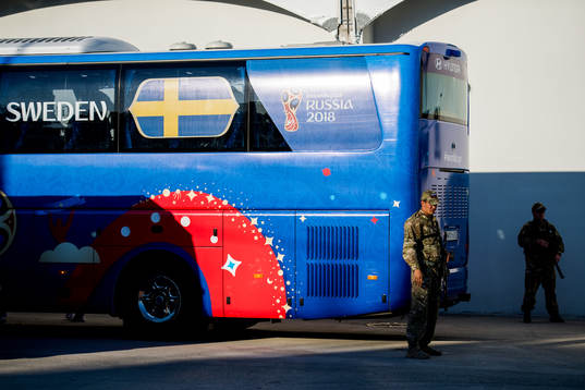 Heavily armed military guards by the Swedish bus