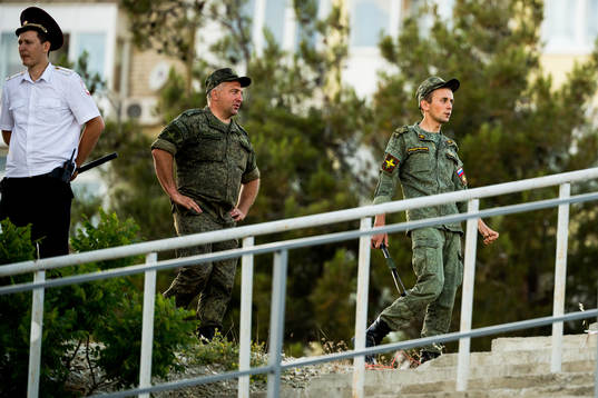Military personnel following the Swedish national football