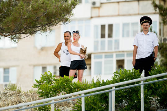 A couple and a police officer following the Swedish