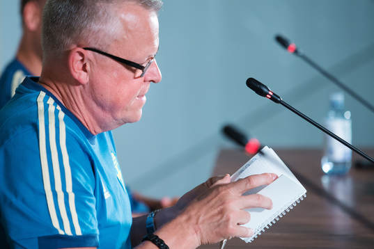 Head coach Janne Andersson shows his notebook of the
