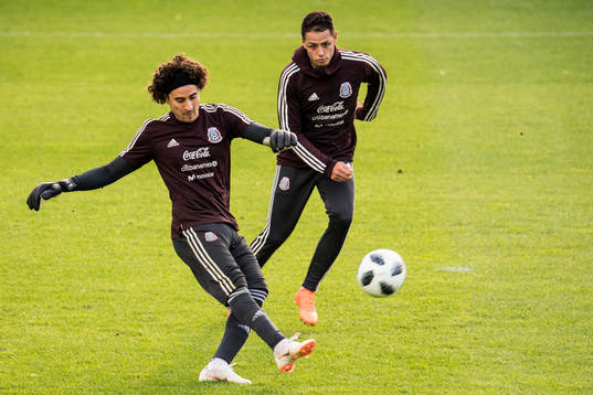 Goalkeeper Guillermo Ochoa and Javier Hernandez of Mexico