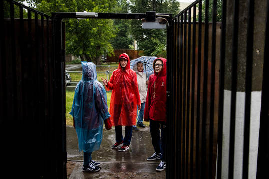 Volunteers is seen in the heavy rain prior team Mexico