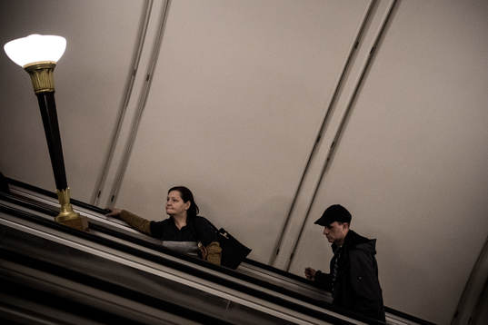 People in the escalator at the metro station