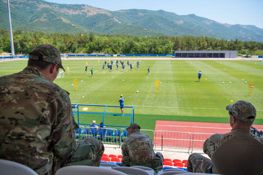 Military personal watch the Swedish national football