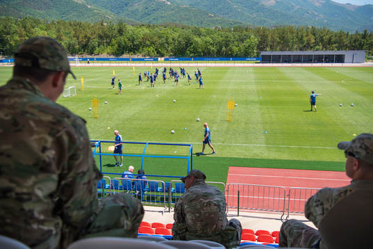 Military personal watch the Swedish national football