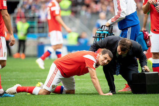 Alan Dzagoev of Russia lies injured