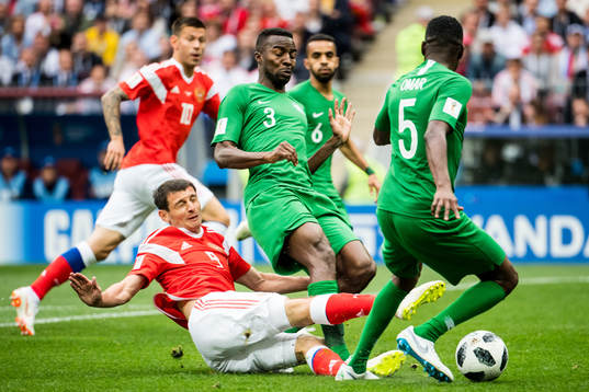 Alan Dzagoev of Russia and Osama Hawsawi of Saudi Arabia