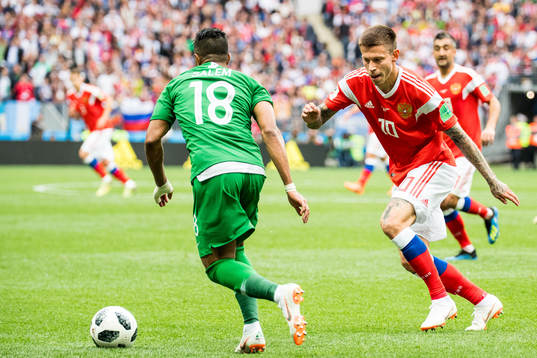 Fedor Smolov of Russia and Salem Aldawsari of Saudi Arabia