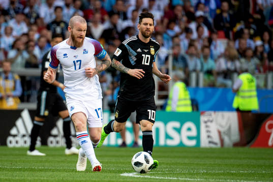 Aron Gunnarsson of Iceland and Lionel Messi of Argentina