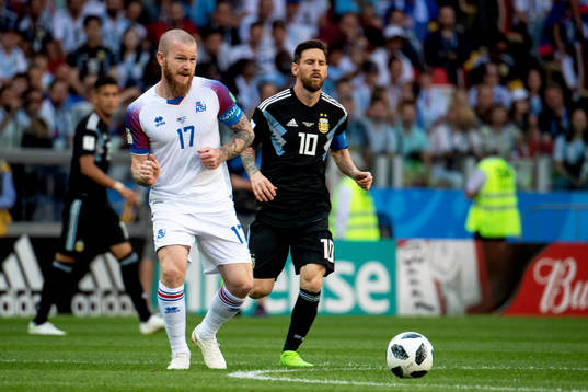 Aron Gunnarsson of Iceland and Lionel Messi of Argentina