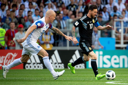 Emil Hallfredsson of Iceland and Lionel Messi of Argentina