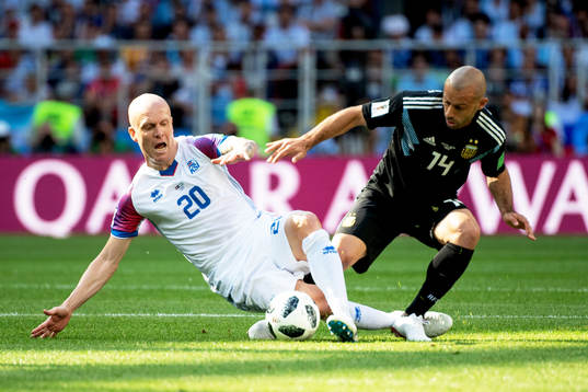 Emil Hallfredsson of Iceland and Javier Mascherano of
