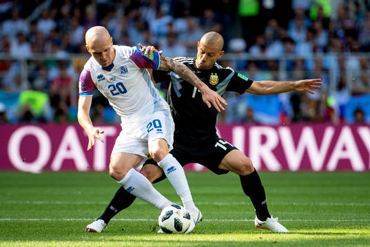 Emil Hallfredsson of Iceland and Javier Mascherano of