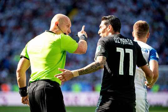referee Szymon Marciniak and Angel Di Maria of Argentina
