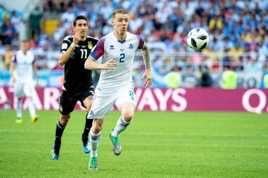 Angel Di Maria of Argentina and Birkir Saevarsson of Iceland
