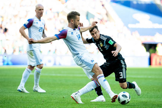 Kari Arnason of Iceland and Nicolas Tagliafico of Argentina