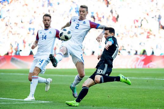 Birkir Saevarsson of Iceland and Lionel Messi of Argentina
